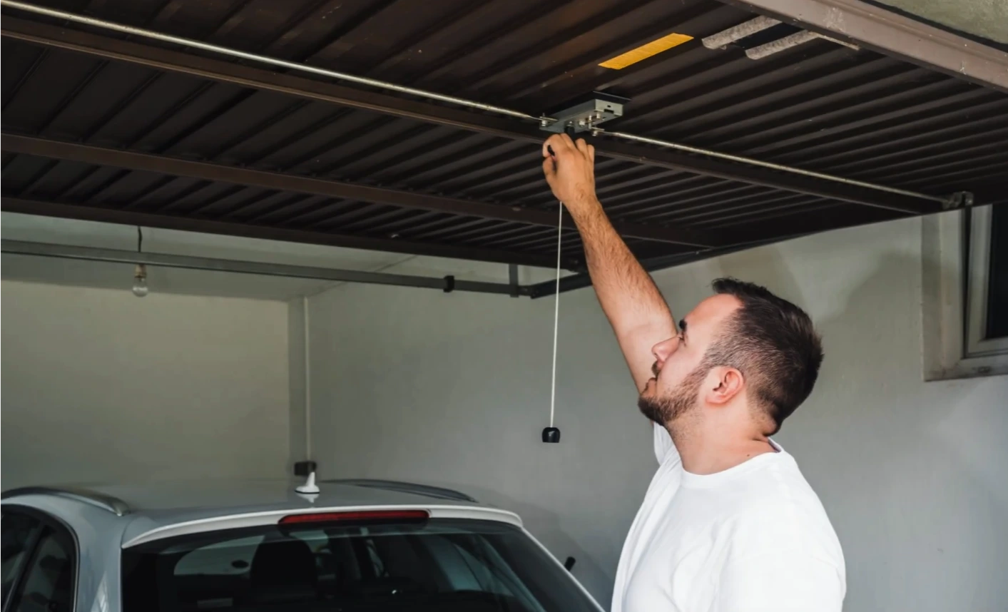 Garage door closing safely at a home in the evening
