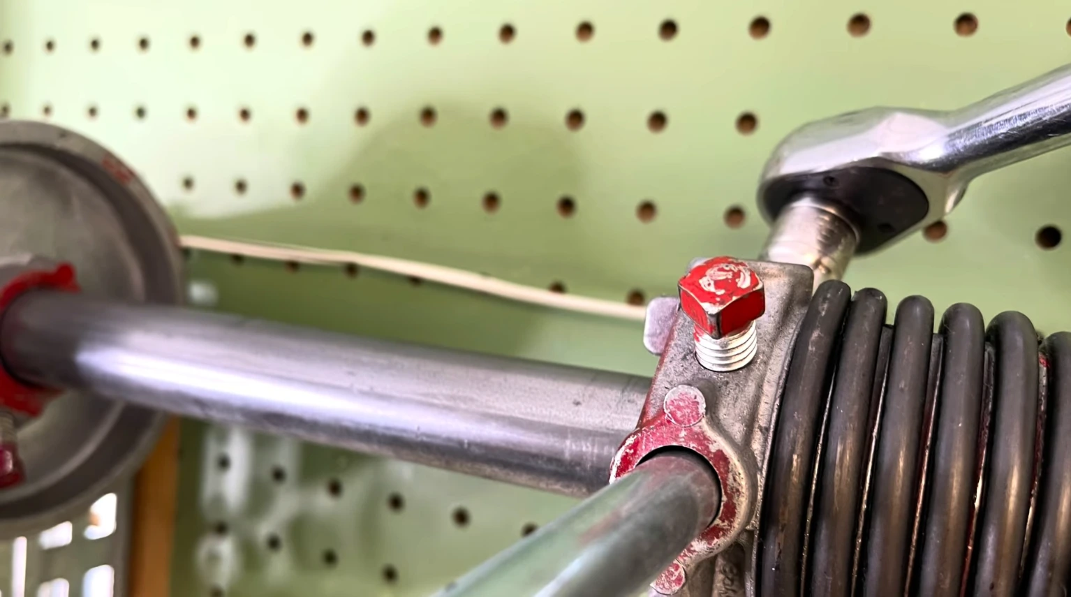 Torsion spring mounted above a garage door before repair in Franklin, TN