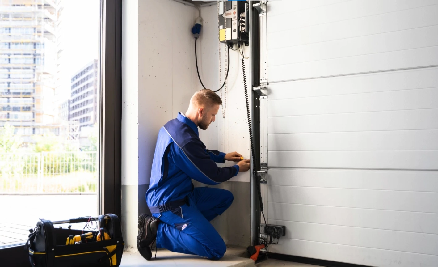 Garage door repair Franklin, TN technician adjusting a torsion spring
