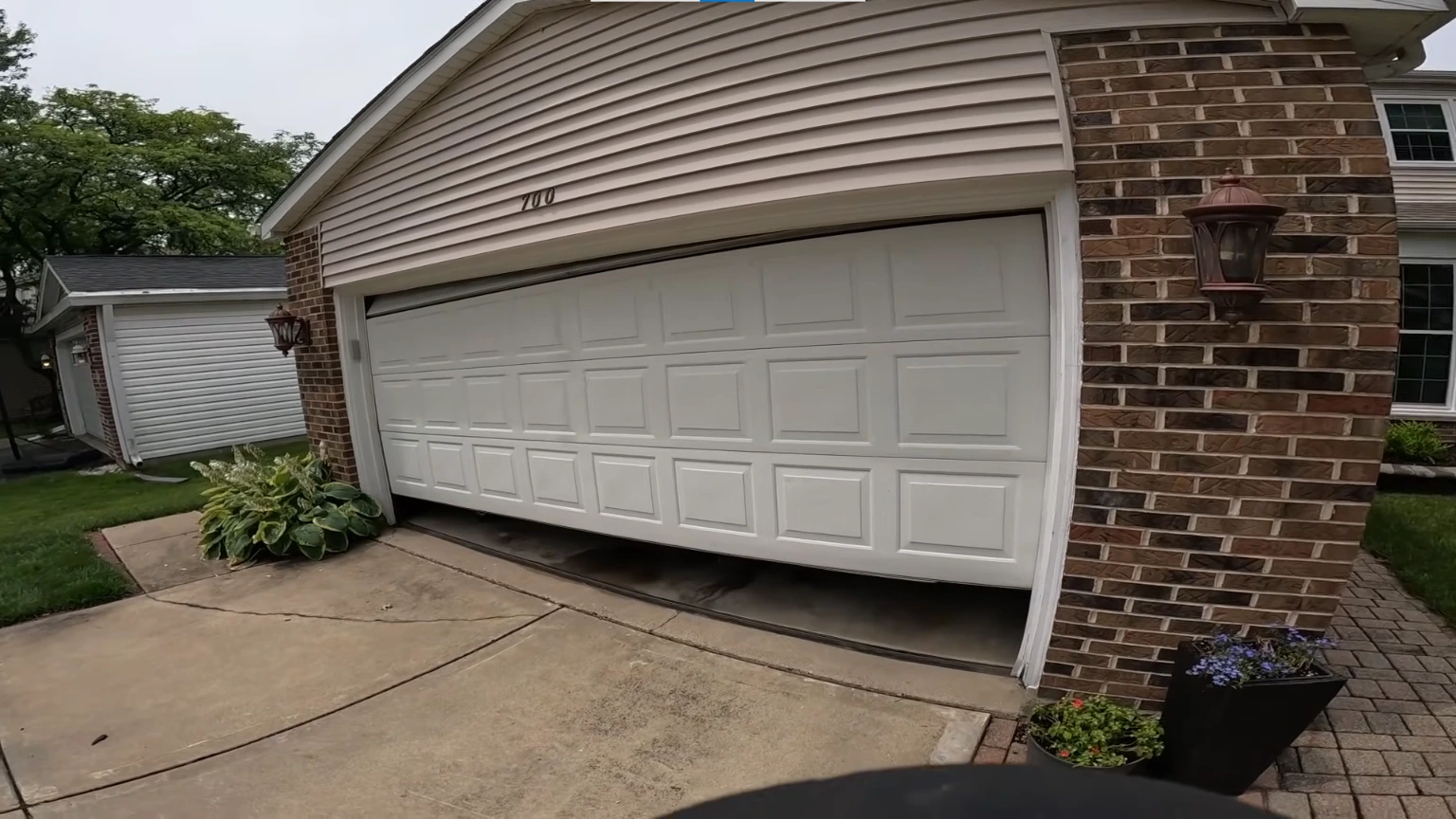 Technician replacing a garage door cable safely